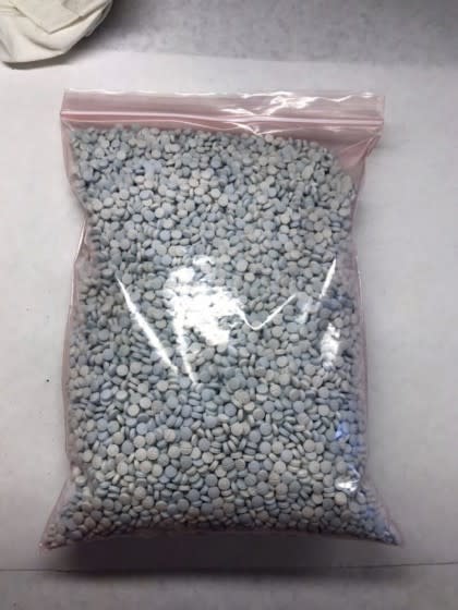 This undated photo released by the Arizona office of the Drug Enforcement Administration shows some of the 1.1 million fentanyl pills that have been seized in the state this fiscal year. DEA Special Agent in Charge Doug Coleman says most pills seized so far in the year ending Sept. 30, 2019 were made to mimic oxycodone M-30 tablets. Coleman says the pills known as "Mexican oxy" are largely manufactured south of the border and smuggled into the United States by drug cartels. He says the growing number being seen is "alarming." (Drug Enforcement Administration via AP)