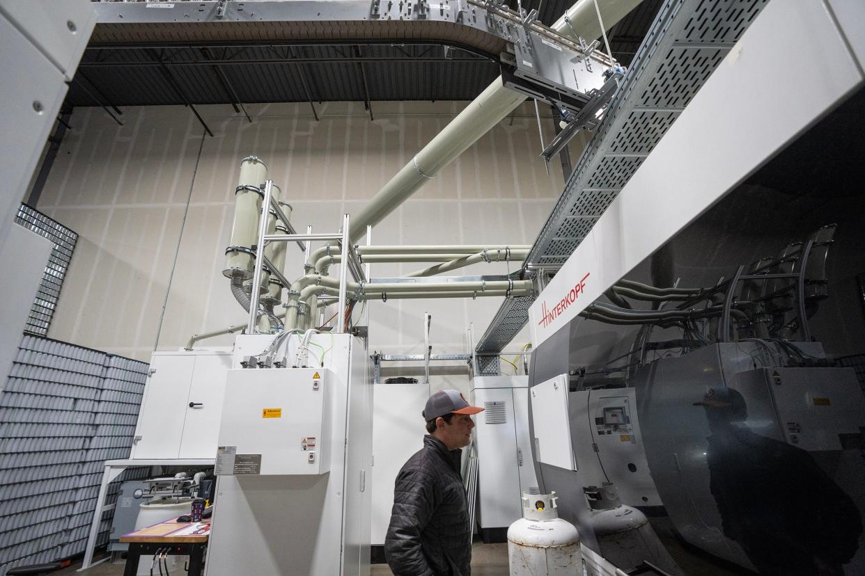 Canworks co-owner Marshall Thompson oversees a printing machine in the warehouse at Canworks Wednesday, Jan. 16, 2024. The facility prints branding artwork onto thousands of aluminum cans a day, helping businesses across the country.