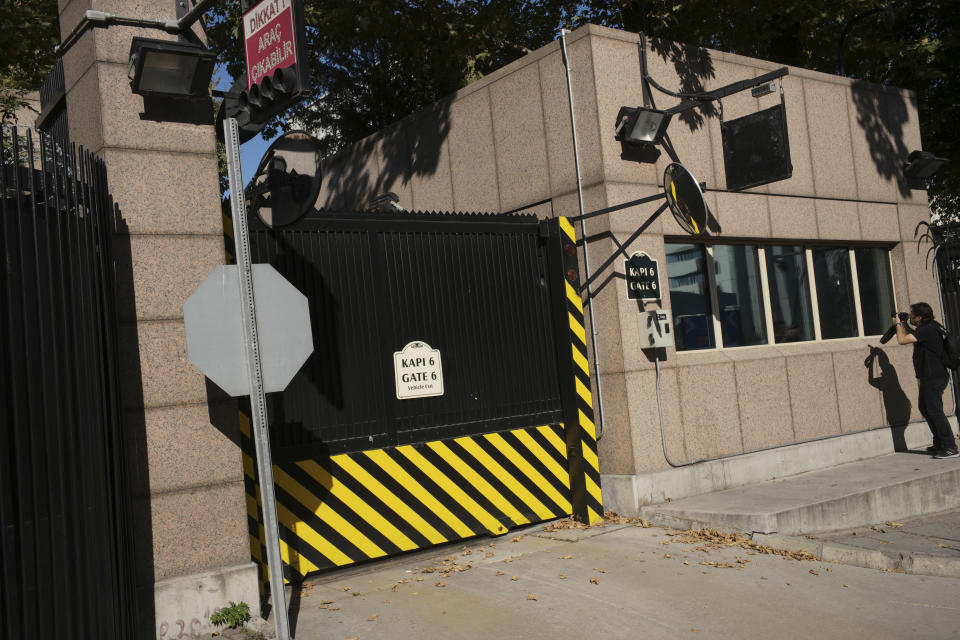 A news photographer takes pictures of the damage to a security booth by a shot fired, outside the U.S. Embassy in Ankara, Turkey, Monday, Aug. 20, 2018. Shots were fired at a security booth outside the embassy in Turkey's capital early Monday, but U.S. officials said no one was hurt. Ties between Ankara and Washington have been strained over the case of an imprisoned American pastor, leading the U.S. to impose sanctions, and increased tariffs that sent the Turkish lira tumbling last week. (AP Photo/Burhan Ozbilici)