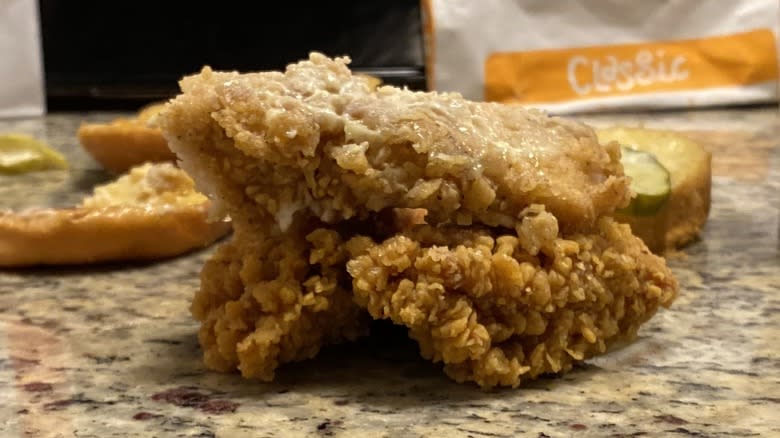 KFC and Popeye's chicken filets stacked