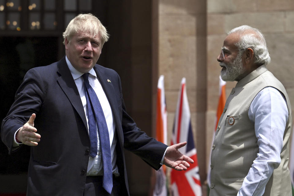 Britain's Prime Minister Boris Johnson, left, gestures as his Indian counterpart Narendra Modi watches before their meeting at Hyderabad House in New Delhi Friday, April 22, 2022. (Ben Stansall/Pool Photo via AP)