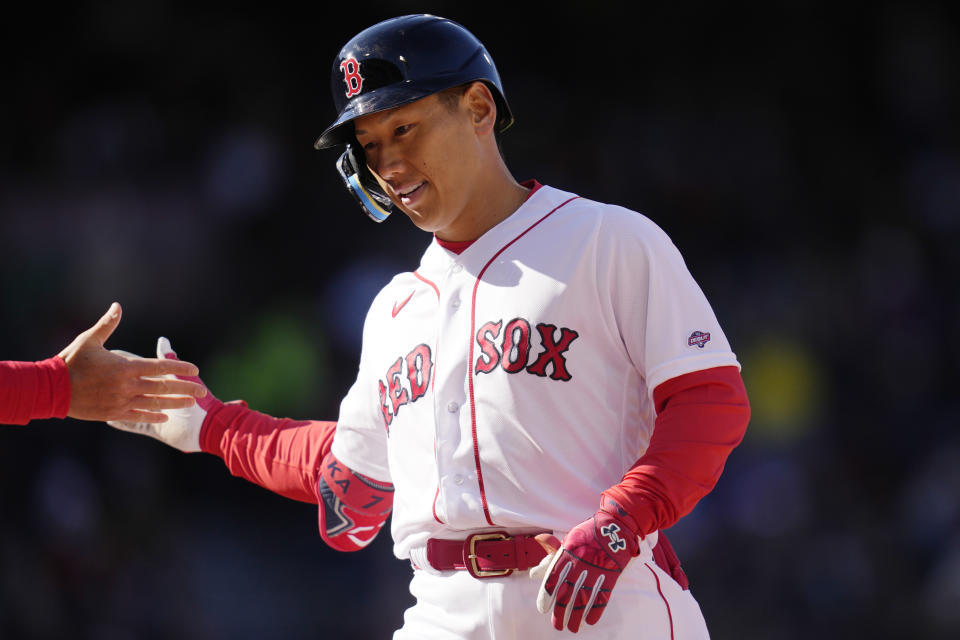 Boston Red Sox's Masataka Yoshida is congratulated after his single in the sixth inning of an opening day baseball game against the Baltimore Orioles at Fenway Park, Thursday, March 30, 2023, in Boston. (AP Photo/Charles Krupa)