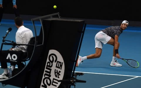 Russia's Karen Khachanov hits a return against Australia's Nick Kyrgios during their men's singles match on day six of the Australian Open tennis tournament in Melbourne on January 25, 2020