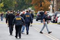 Police officers walk near the site where Ahmad Khan Rahami, sought in connection with a bombing in New York, was taken into custody in Linden, New Jersey, U.S., September 19, 2016. REUTERS/Eduardo Munoz