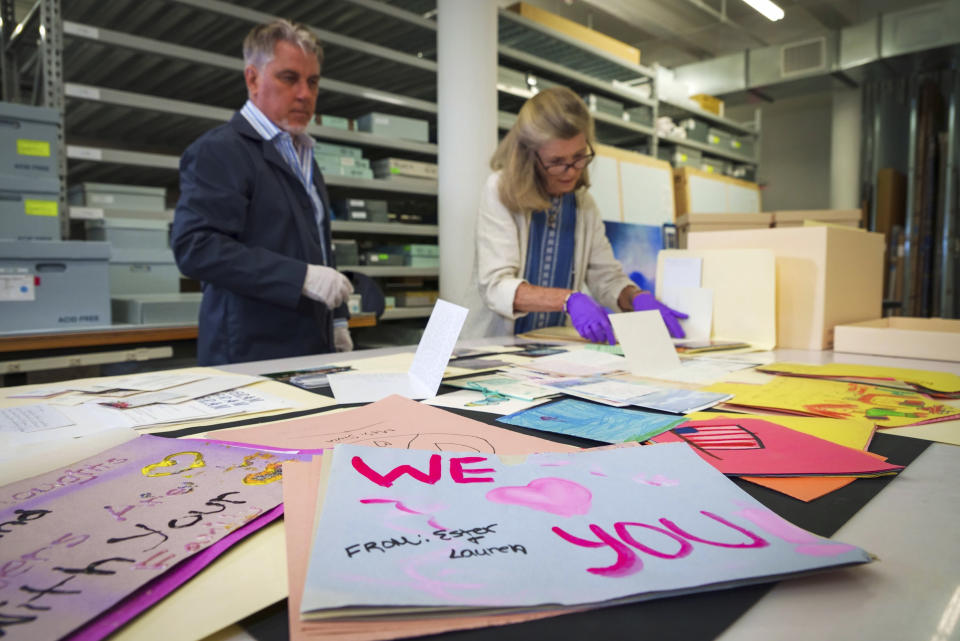 Jan Ramirez, chief curator at the 9/11 Memorial & Museum, right, sifts through a collection of condolence cards for a victim of 9/11 that were donated to the museum's archive, July 16, 2021, in Jersey City, N.J. Over the years, the museum has collected some 22,000 personal artifacts to help tell the stories of those who died and those lucky to survive. Many of those personal effects were plucked from the ruins of what was once the Twin Towers. Other items were donated by survivors or by the families of those who perished. (AP Photo/Robert Bumsted)