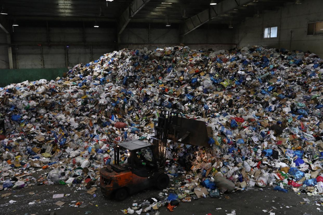 <p> A forklift truck moves household waste at a facility in Seoul, South Korea  </p> (Getty)