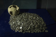 Silver coins and a ceramic pot from the Gaznvied period which run from 977 to 1186 are displayed in The National Museum of Afghanistan, in Kabul, Monday, Dec. 6, 2021. The National Museum of Afghanistan is open once again -- and the Taliban, whose members once smashed their way through the facility, destroying irreplaceable pieces of Afghanistan's national heritage, now appear to be among its most enthusiastic visitors. (AP Photo/ Petros Giannakouris)
