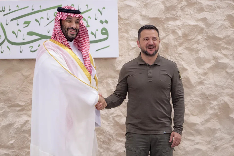 In this photo provided by Saudi Press Agency, SPA, Saudi Crown Prince Mohammed bin Salman greets Ukraine's President Volodymyr Zelenskyy, right, during the Arab summit in Jeddah, Saudi Arabia, Friday, May 19, 2023. (Saudi Press Agency via AP)