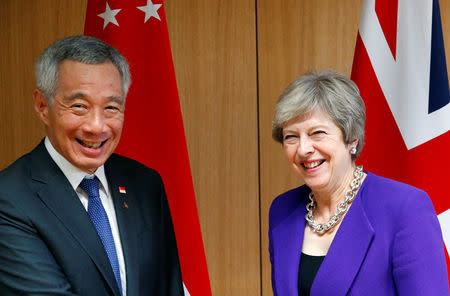 Singapore's Prime Minister Lee Hsien Loong poses with Britain's counterpart Theresa May at the ASEM leaders summit in Brussels, Belgium October 18, 2018. REUTERS/Francois Lenoir/Pool