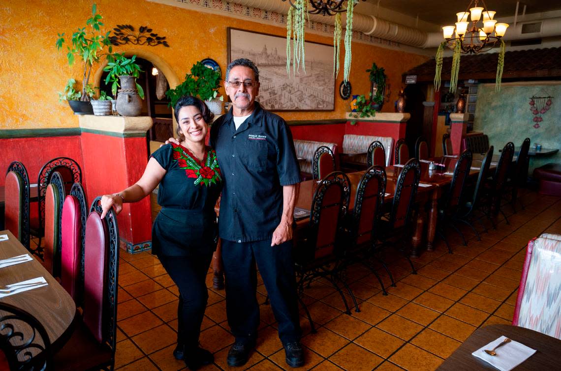 Urmilae Unzueta, left, stands with her dad Roy Unzueta, co-owner of Caballo Blanco restaurant in Sacramento’s South City Farms neighborhood Friday.