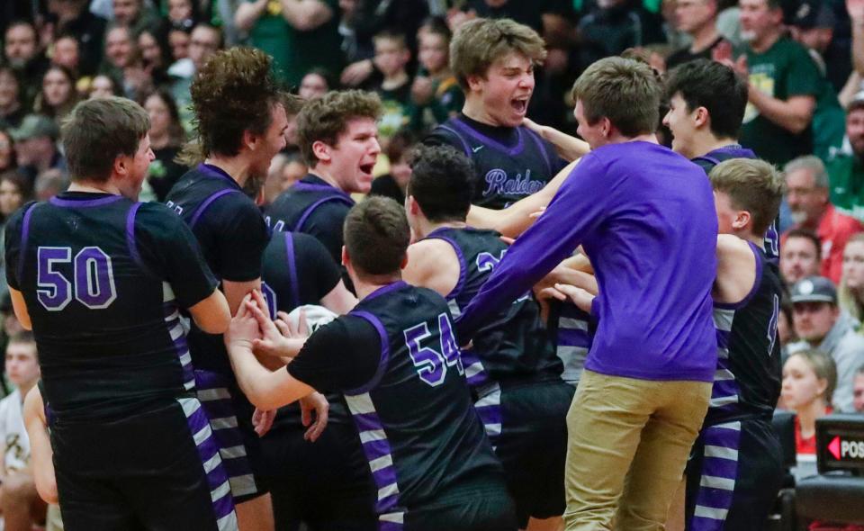 Kiel players celebrate their WIAA Division 3 boys basketball sectional final victory over Freedom at Manitowoc Lincoln on Saturday.