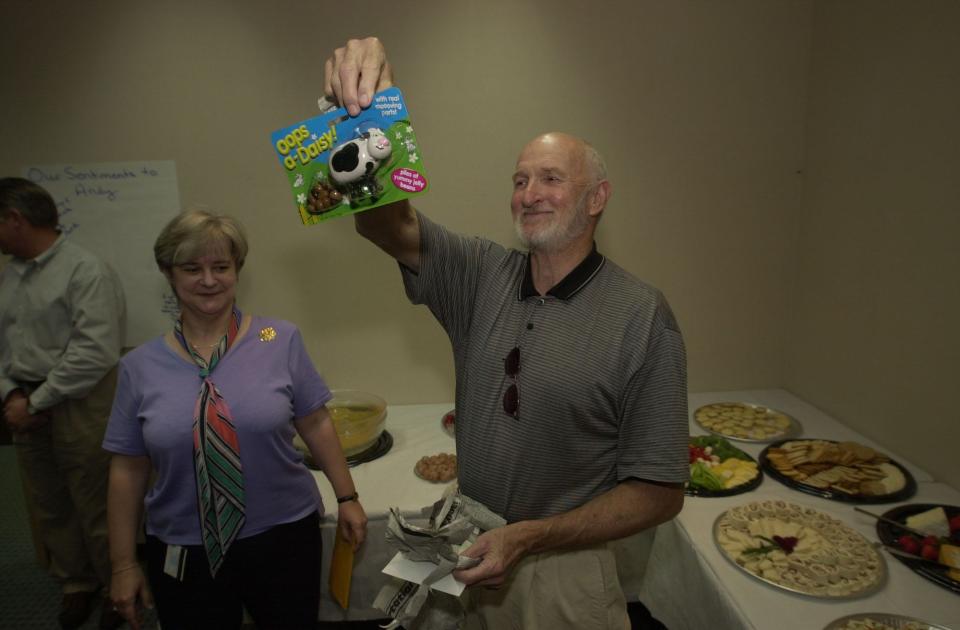 StarNews Executive Editor Charles Anderson shows off a jellybean dispensing cow during his retirement party at the StarNews in 2001.