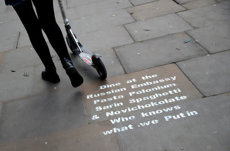 Graffiti sprayed on the pavement near the entrance to the Russian embassy and ambassador's residence in London, Britain, March 15, 2018. REUTERS/Hannah McKay