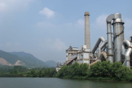 Anhui Conch cement plant is seen by a river in Tongling