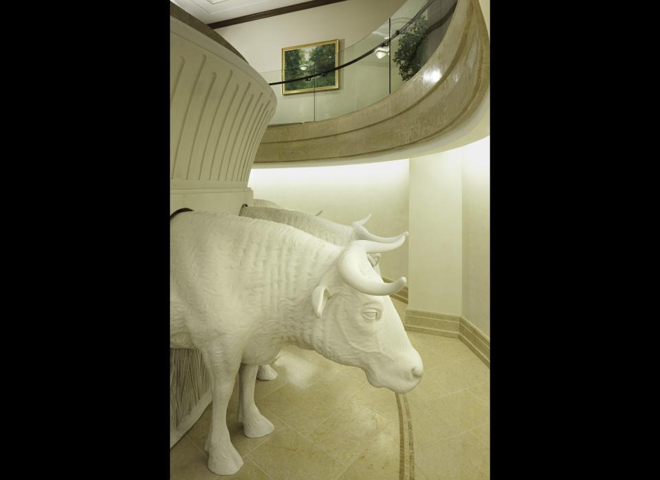 Oxen under the baptismal font in the Kansas City Missouri Temple. All Latter-day Saint baptismal fonts are supported on the backs of 12 oxen statues that symbolize the twelve tribes of Israel.