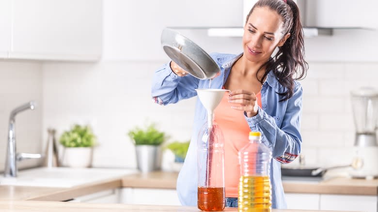 woman pouring cooking oil into disposable containers