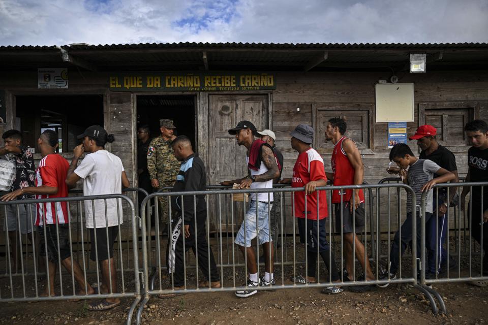 Migrants line up to receive food at the Reception Center for Migrant Care in Lajas Blancas, in the jungle province of Darién, Panama, on June 27, 2024.