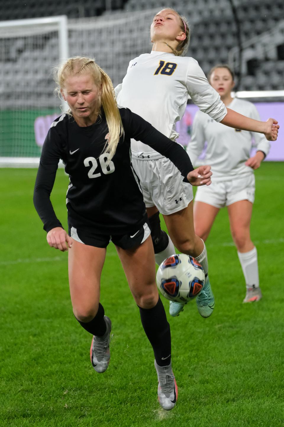 Waynesville forward Adelynn Harrison (28) goes up for a ball against Ottawa-Glendorf midfielder Lily Haselman (18) during the OHSAA girls Division III state soccer championship at Lower.com Field in Columbus, Ohio, Friday, Nov. 12, 2021.