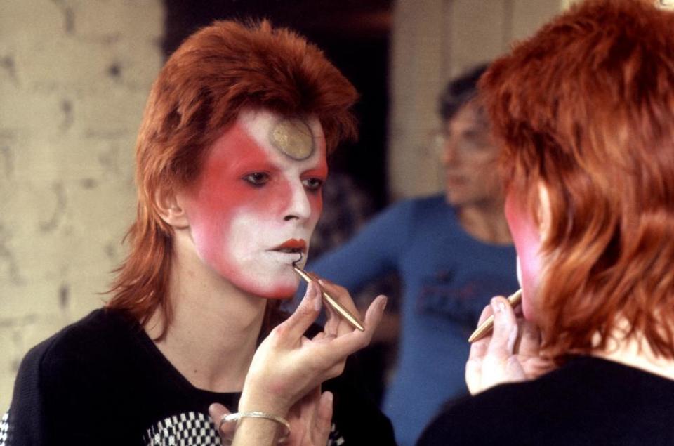 David Bowie applies makeup during his Ziggy Stardust incarnation.