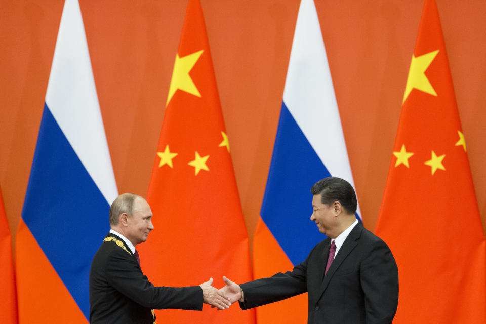 FILE - Chinese President Xi Jinping, right, and Russian President Vladimir Putin shake hands during an awarding ceremony at the Great Hall of the People in Beijing, China, on June 8, 2018. Xi is keeping the West guessing about whether Beijing will cooperate with tougher sanctions on Russia as he meets President Vladimir Putin a year after declaring they had a “no limits” friendship ahead of the Kremlin’s invasion of Ukraine. (AP Photo/Alexander Zemlianichenko, Pool, File)