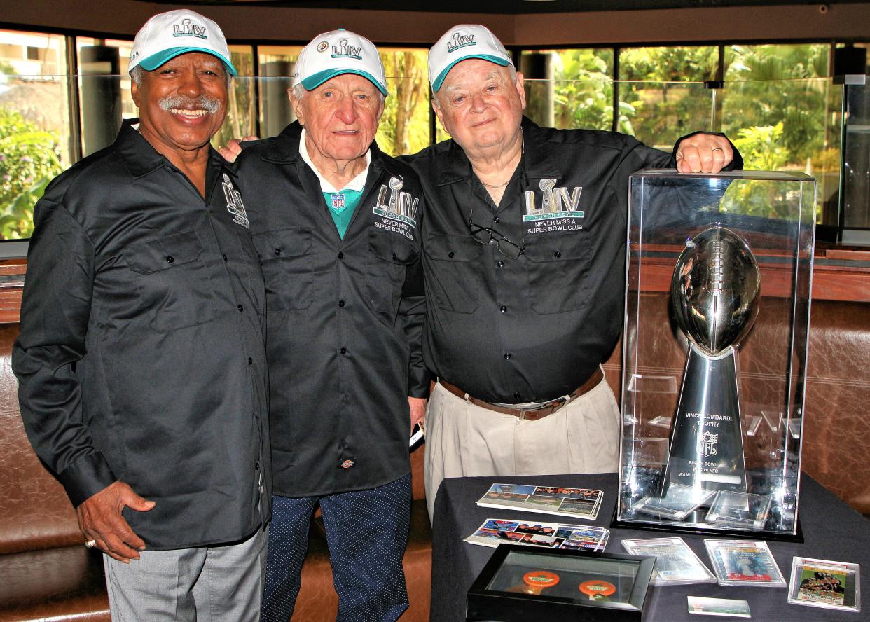 Greg Eaton of Lansing, left, joins  Tom Henschel of Pittsburgh and Florida and Don Crisman of Maine, all  members of the Never Miss A Super Bowl Club.