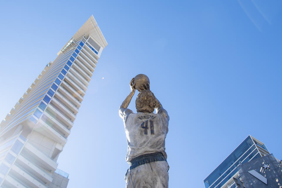 Dirk Nowitzki's statue is unveiled during the "All Four One" statue ceremony in front of the American Airlines Center in Dallas, Sunday, Dec. 25, 2022. (AP Photo/Emil T. Lippe)