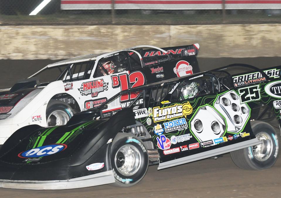 Jason Feger (25) and Kevin Weaver (12) race for the lead early in last Friday's racing program at the Kankakee County Speedway. Feger went on to win his first MARS feature of the year.