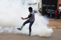 A man reacts to tear gas fired by police fire to disperse rival marches by hundreds of protesters, after mobs looted stores this week believed to belong to immigrants in Pretoria, South Africa, February 24, 2017. REUTERS/ James Oatway.