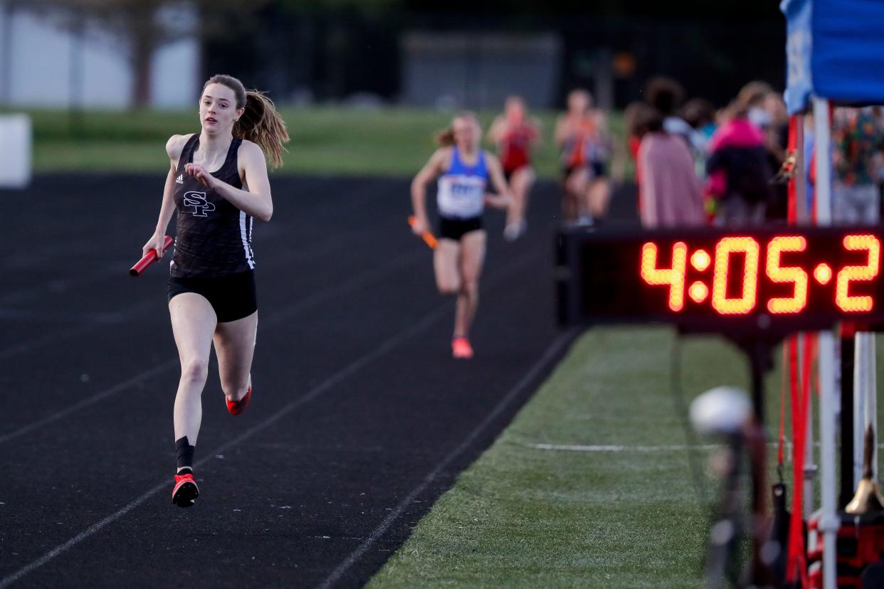 SPASH’s Roisin Willis looks at the clock as she nears the finish line of the 4x400 relay during the Wisconsin Valley Conference track and field meet May 17 at Merrill High School. Willis could set the state record in the 800 this weekend in La Crosse.