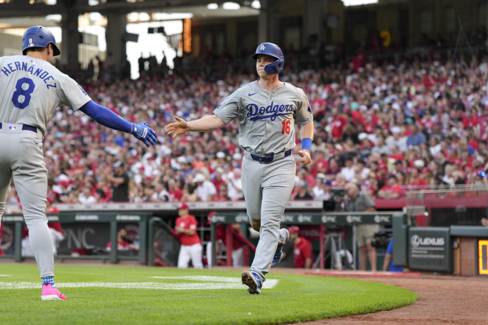 Los Angeles Dodgers' Will Smith (16) celebrates with eammate Enrique Hernández (8) after scoring on a hit by Jason Heyward which resulting in a double play during the second inning of a baseball game against the Cincinnati Reds, Saturday, May 25, 2024, in Cincinnati. (AP Photo/Jeff Dean)