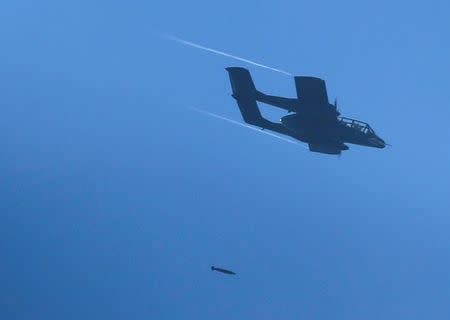 A Philippines army aircraft releases a bomb during an airstrike as government troops continue their assault against insurgents from the Maute group in Marawi city June 27, 2017. REUTERS/Jorge Silva