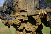 <p>A first-year midshipman, known as a “plebe,” carries a dummy rifle covered in mud during Sea Trials, a day-long training exercise that caps off their plebe year at the U.S. Naval Academy in Annapolis, Md., Tuesday, May 16, 2017. (Photo: Patrick Semansky/AP) </p>