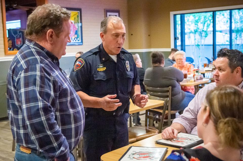 Lafayette Police Chief Monte Potier talks with customers Wednesday as the Lafayette Police Officers wait tables at Deano's Pizza, with tips going to Boys and Girls Clubs of Acadiana.