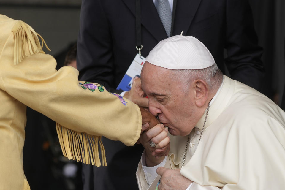 Pope Francis kisses hand to Canadian Indigenous woman as he arrives at Edmonton's International airport, Canada, Sunday, July 24, 2022. Pope Francis crisscrossed Canada this week delivering long overdue apologies to the country's Indigenous groups for the decades of abuses and cultural destruction they suffered at Catholic Church-run residential schools. (AP Photo/Gregorio Borgia)