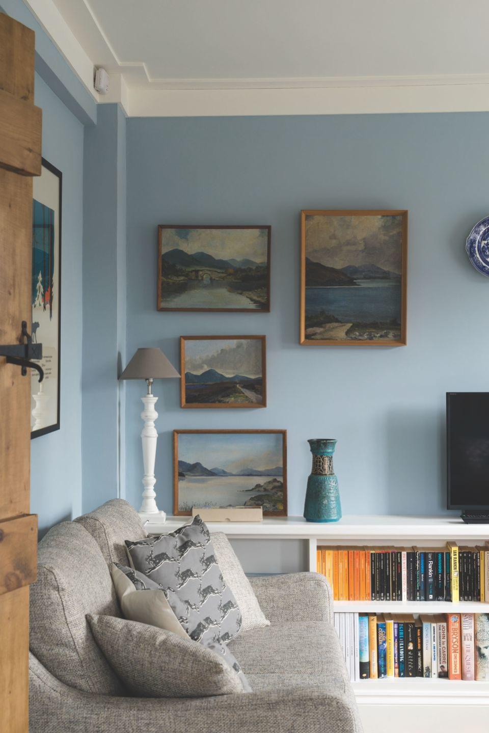 a living room with a couch and a book shelf