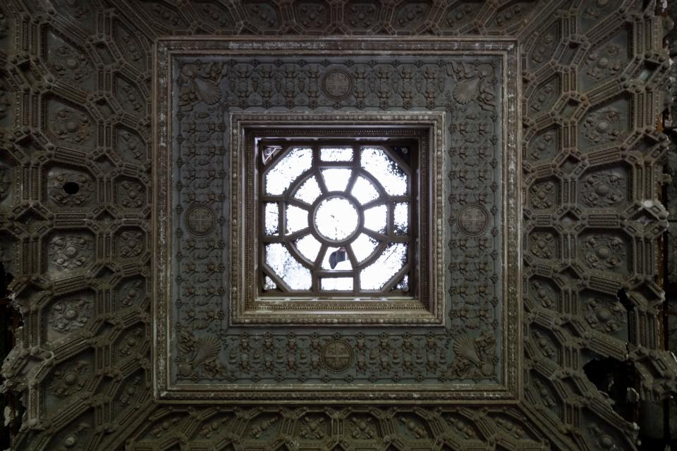 A decorated ceiling within the mansion.