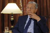 Malaysia's Prime Minister Mahathir Mohamad listens during an interview with The Associated Press in Putrajaya, Malaysia, Monday, Aug. 13, 2018. Mahathir said he will seek to cancel multibillion-dollar Chinese-backed infrastructure projects that were signed by his predecessor as his government works to dig itself out of debt, and he blasted Myanmar’s treatment of its Rohingya minority as "grossly unjust." (AP Photo/Yam G-Jun)