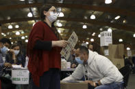 A voter waits to cast her ballot during presidential elections in Bogota, Colombia, Sunday, May 29, 2022. (AP Photo/Leonardo Munoz)