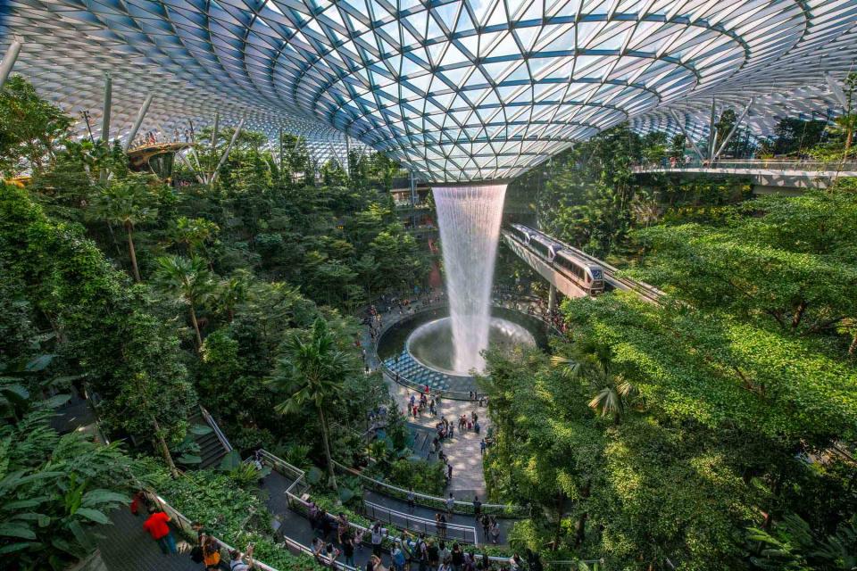 <p>Courtesy of Singapore Changi Group</p> Not your typical in-terminal amenity: the Rain Vortex at Singapore Changi Airport.