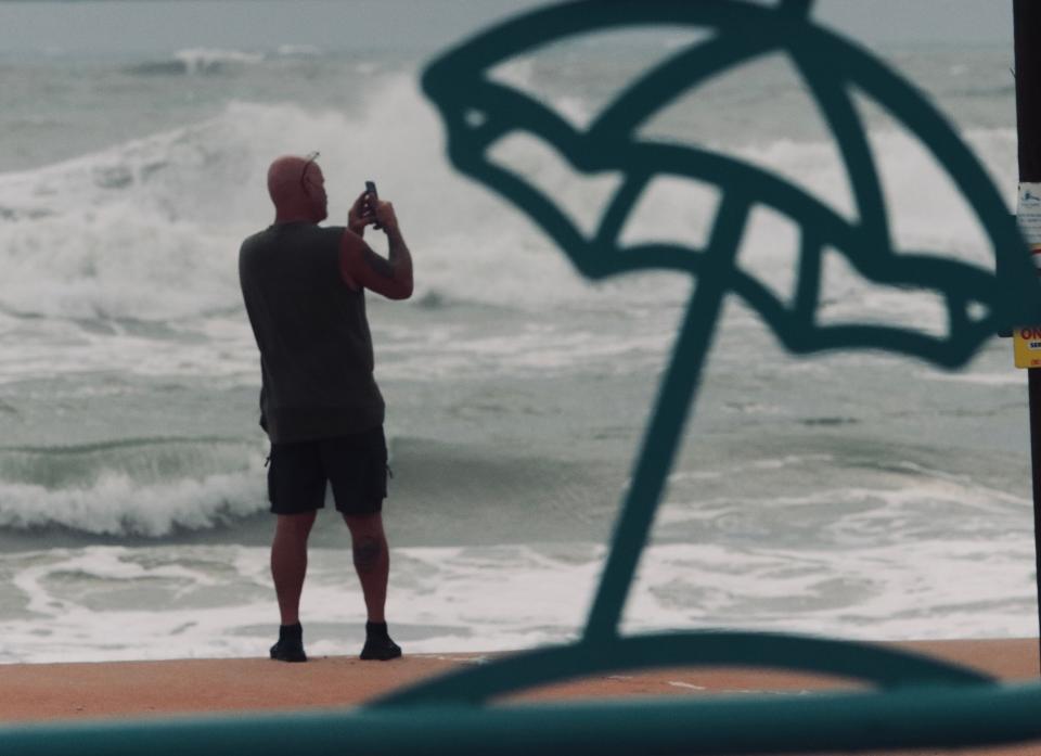 A beachgoer checks out the surf churned up by Idalia at the Granada Boulevard ramp in Ormond Beach on Wednesday, Aug. 30, 2023.