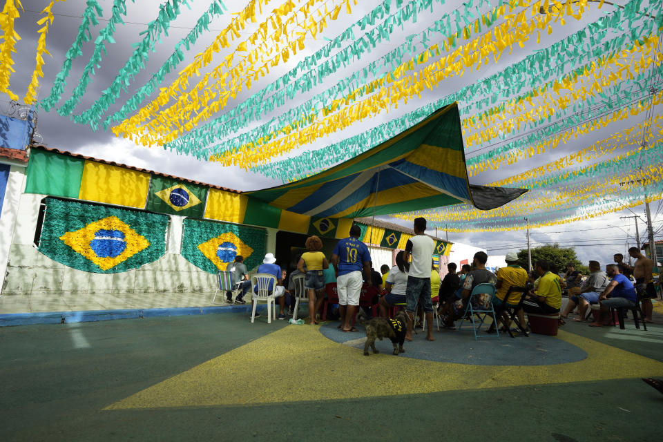 Brazil soccer fans watch their team's World Cup match against Serbia, played in Qatar, on a screen in Brasilia, Brazil, Thursday, Nov. 24, 2022. (AP Photo/Eraldo Peres)