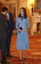 <p>The Duchess made her first public appearance at a Buckingham Palace reception since announcing <a href="https://www.townandcountrymag.com/society/tradition/a12167619/kate-middleton-due-date-2018/" rel="nofollow noopener" target="_blank" data-ylk="slk:her third pregnancy;elm:context_link;itc:0;sec:content-canvas" class="link ">her third pregnancy</a>. Though Duchess Kate is still <a href="https://www.townandcountrymag.com/society/tradition/a12185279/kate-middleton-hyperemesis-gravidarum-morning-sickness-meaning/" rel="nofollow noopener" target="_blank" data-ylk="slk:suffering from Hyperemesis Gravidarum;elm:context_link;itc:0;sec:content-canvas" class="link ">suffering from Hyperemesis Gravidarum</a>, her light blue, Temperley dress set a cheery tone over her new <a href="https://www.townandcountrymag.com/society/tradition/a12810469/kate-middleton-baby-bump-photos/" rel="nofollow noopener" target="_blank" data-ylk="slk:baby bump;elm:context_link;itc:0;sec:content-canvas" class="link ">baby bump</a>. The knee-length, lace ensemble had black detailing in its front buttons and bowtie neckline, to which Kate matched a black clutch, black pumps, and a pair of blue topaz and diamond earrings by Kiki McDonough.</p>