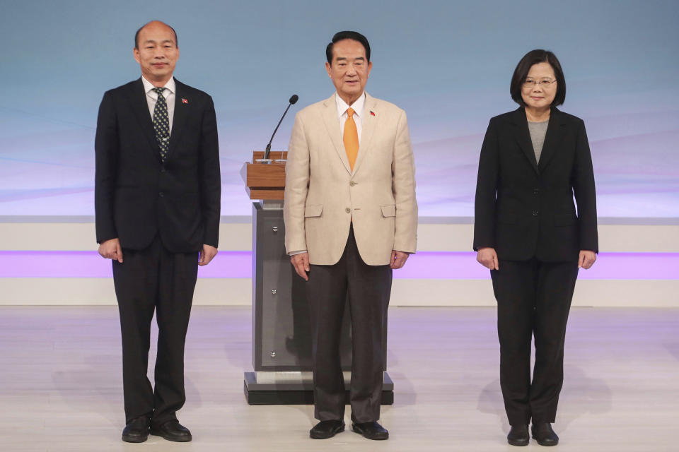 Taiwan's 2020 presidential election candidates, from right, Democratic Progressive Party's Tsai Ing-wen, People First Party's James Soong, and Nationalist Party's Han Kuo-yu pose for a picture at the start of their televised policy debate in Taipei, Taiwan, Sunday, Dec. 29, 2019. Taiwan will hold its general elections on Jan. 11, 2020. (Pool Photo via AP)