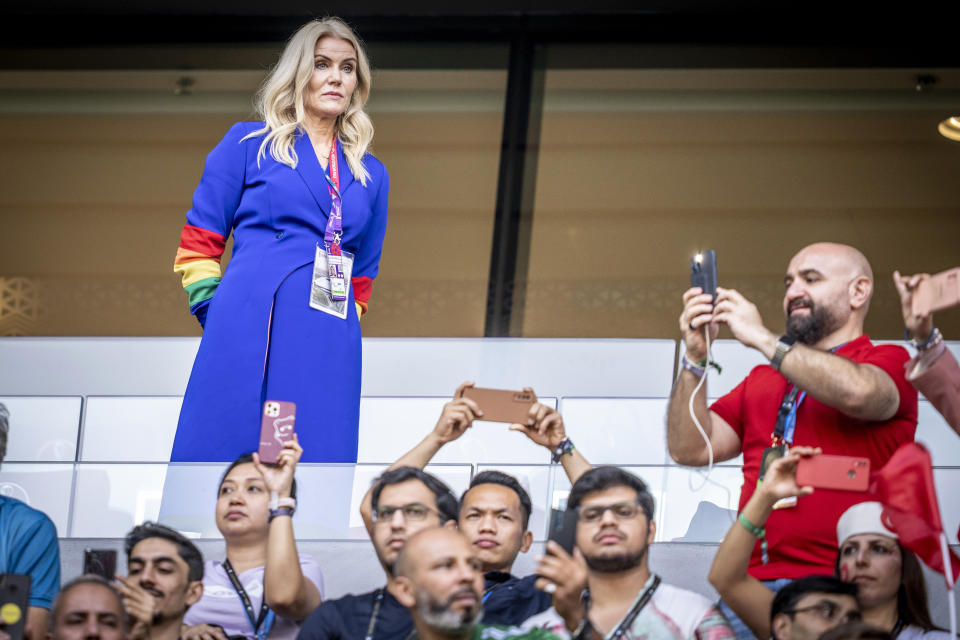 Former Danish Prime Minister Helle Thorning-Schmidt, left, wears a rainbow-colored armband before a World Cup group D soccer match between Denmark and Tunisia, at the Education City Stadium, in Doha, Qatar, Tuesday, Nov, 22, 2022. (Mads Claus Rasmussen/Ritzau Scanpix via AP)