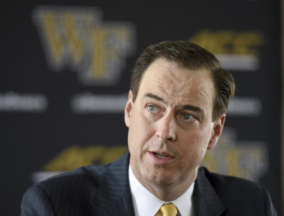 FILE - In this May 6, 2019, file photo, Wake Forest athletic director John Currie talks with the media in Winston-Salem, N.C. The question for schools considering cutting sports in the wake of the coronavirus pandemic isn’t solely a financial one. It's also a legal one that prevents women's sports from being cut to simply balance the books. Currie noted that non-revenue sports frequently have athletes on partial scholarships, meaning a team roster could have the equivalent of numerous athletes paying full tuition. So cutting a sport might reduce expenses for an athletics department yet cause a net revenue loss for a school more broadly. (Walt Unks/Winston-Salem Journal via AP, File)