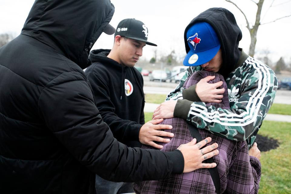 Marcelina Soriano, owner of La Poblanita, a taco and Mexican food trailer usually parked in Clintonville, is comforted by three of her sons Monday at the Columbus police impound lot after coming to reclaim the trailer and seeing the damage done when it was gutted of kitchen equipment and other parts after it was stolen early Saturday morning.