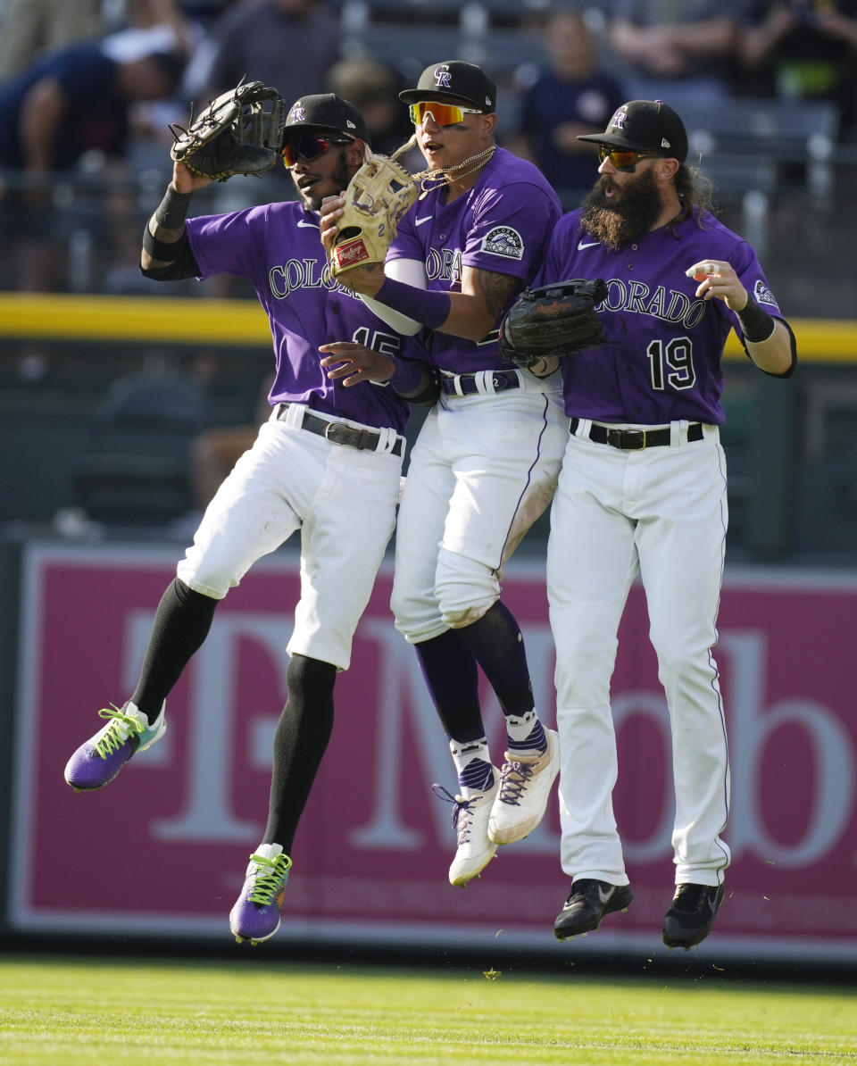 From left to right, Colorado Rockies left fielder Raimel Tapia, center fielder Yonathan Daza and right fielder Charlie Blackmon celebrate after the ninth inning of a baseball game against the Pittsburgh Pirates, Monday, June 28, 2021, in Denver. (AP Photo/David Zalubowski)