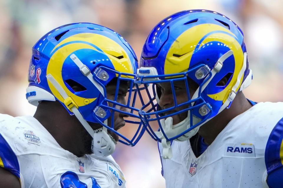 Rams defensive tackle Kobie Turner (left) and defensive tackle Aaron Donald celebrates.