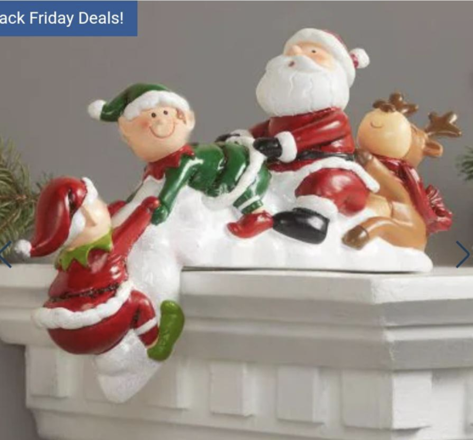 A statue of Santa and his elves, where it looks like Santa is having sex with an elf