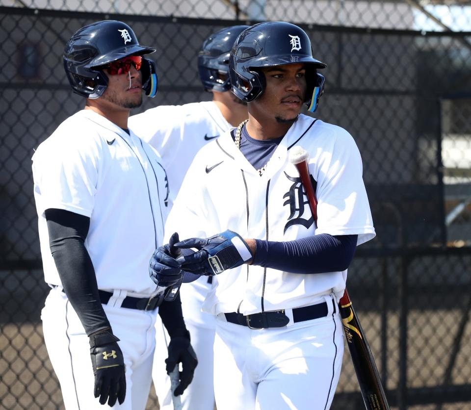 Detroit Tigers prospects Cristian Santana (front) and Roberto Campos (left) wait to take batting practice during spring training minor-league minicamp Monday, Feb. 21, 2022 at Tiger Town in Lakeland, Florida.